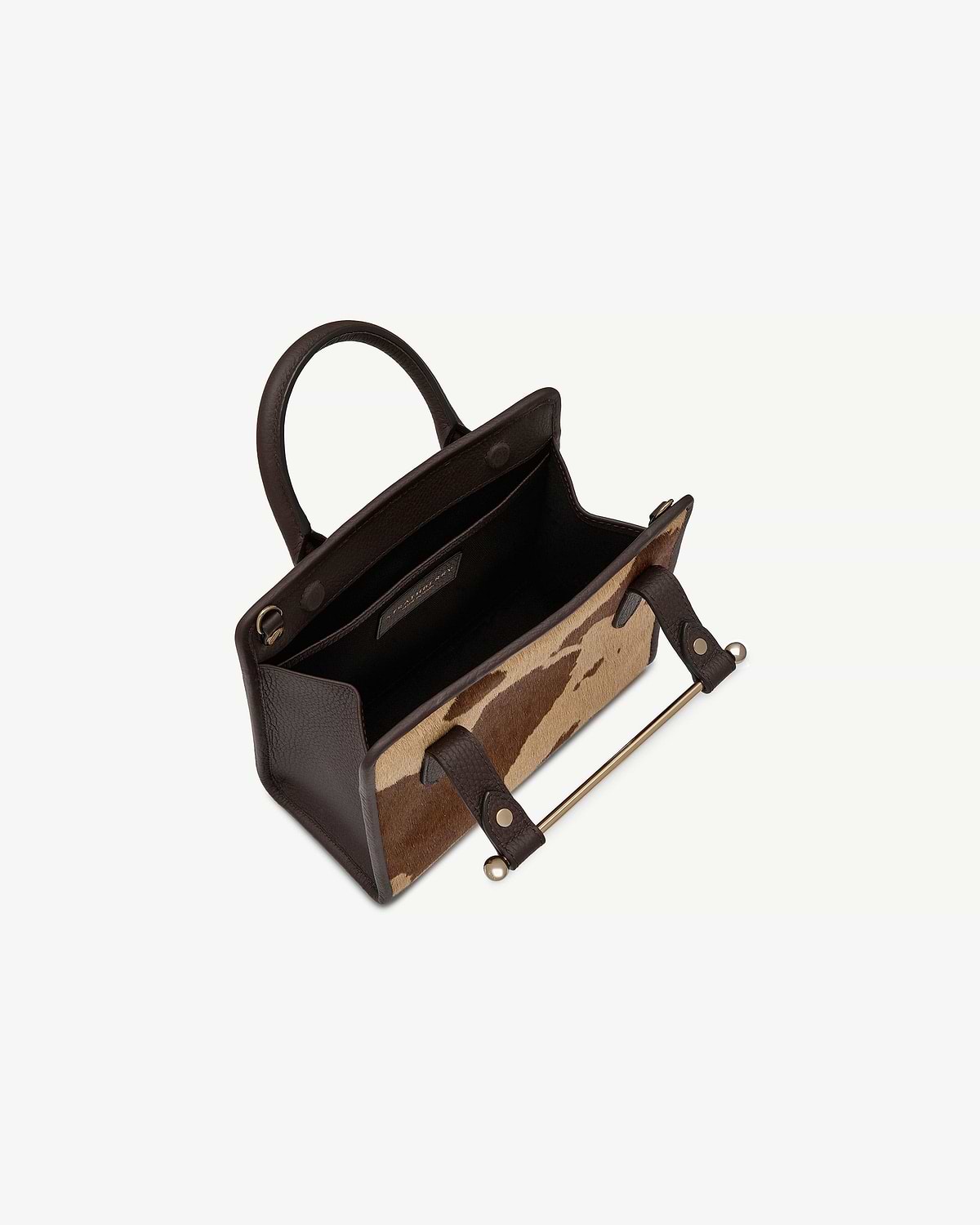 Mini tote with sand and espresso spot print, dark brown handles and gold bar.