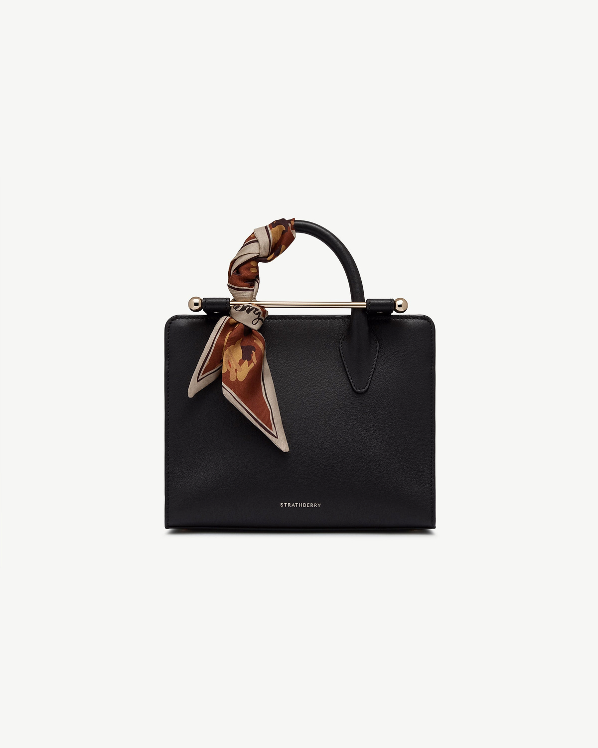 Sand and oxblood pop flowers silk skinny scarf tied to Strathberry handbag handle.