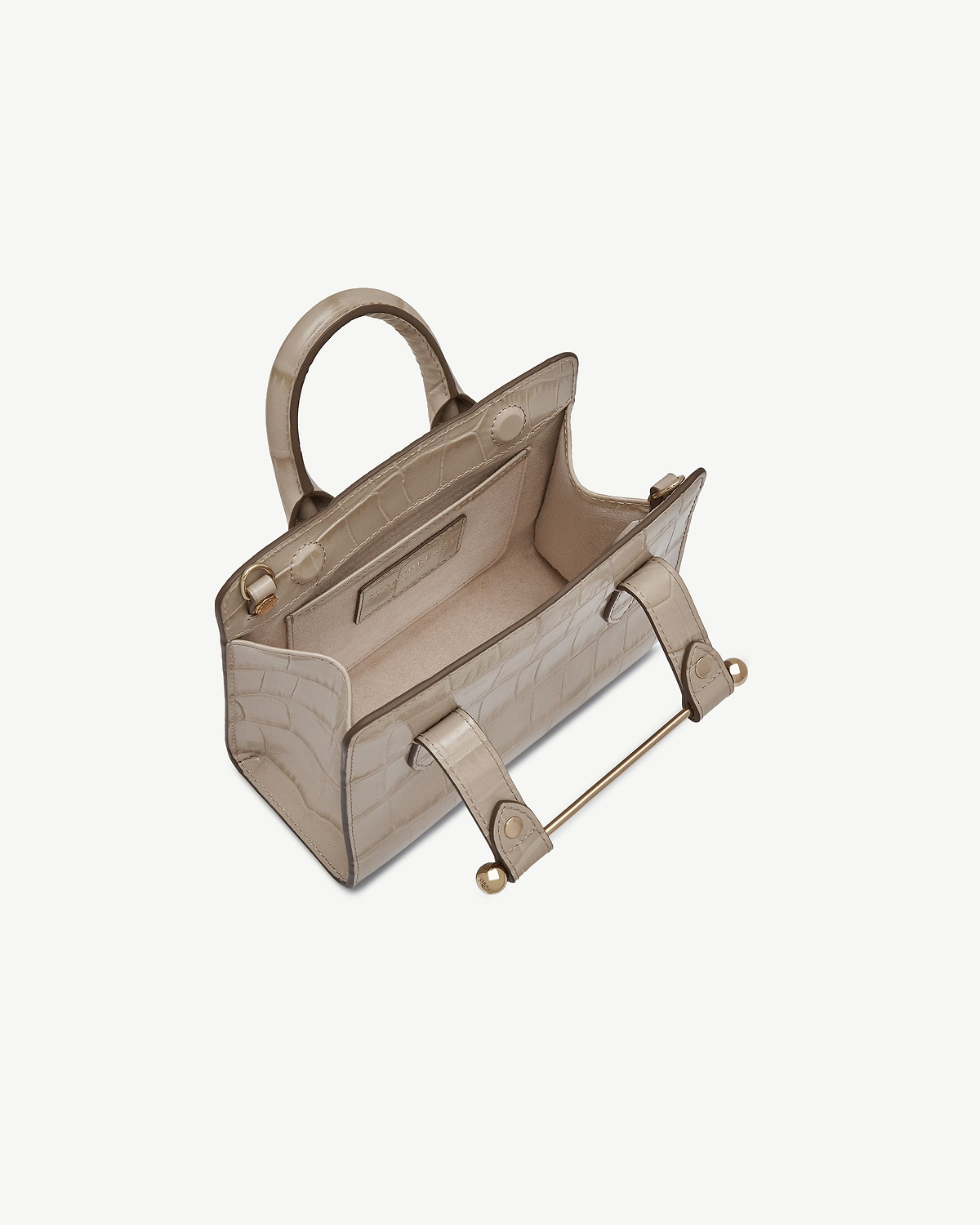 Top view of croc-effect nano tote showing open interior and metal bar handle.