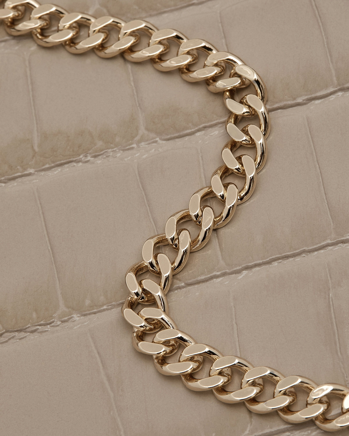 Croc-effect leather with gold chain strap on a nano tote.