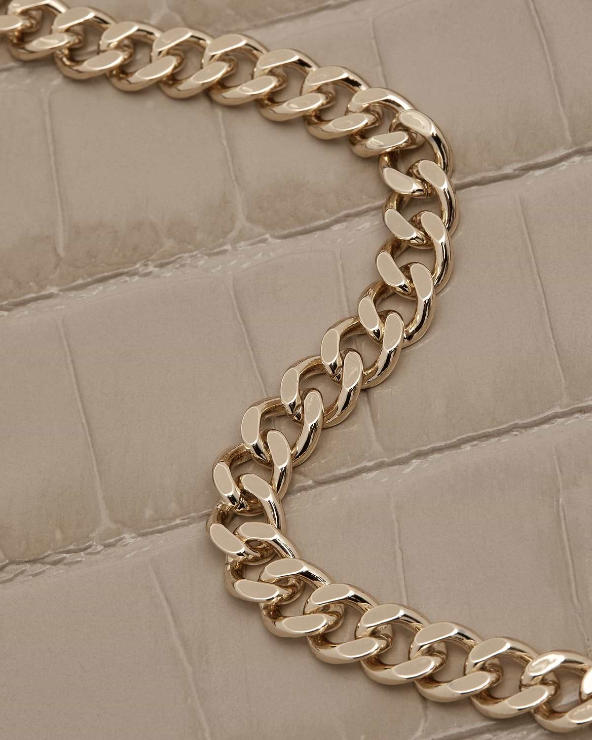 Croc-effect leather with gold chain strap on a nano tote.