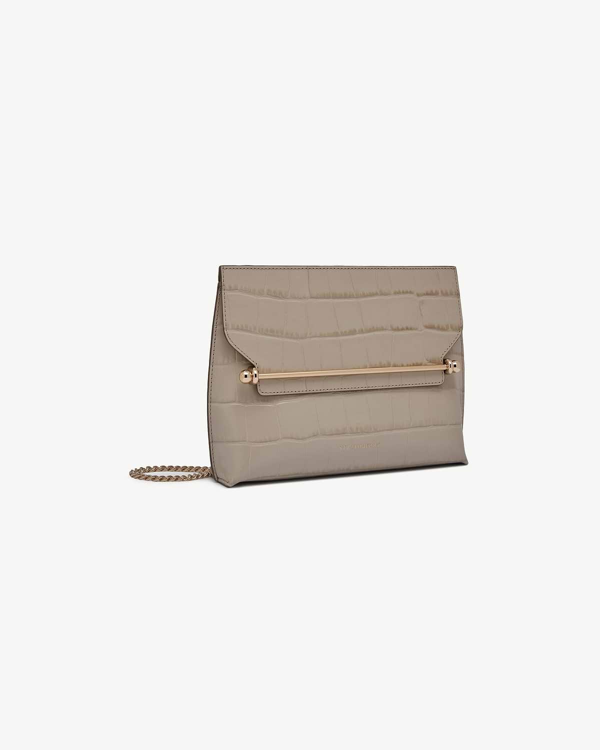 Strathberry Stylist croc-embossed taupe bag with gold bar and chain strap.