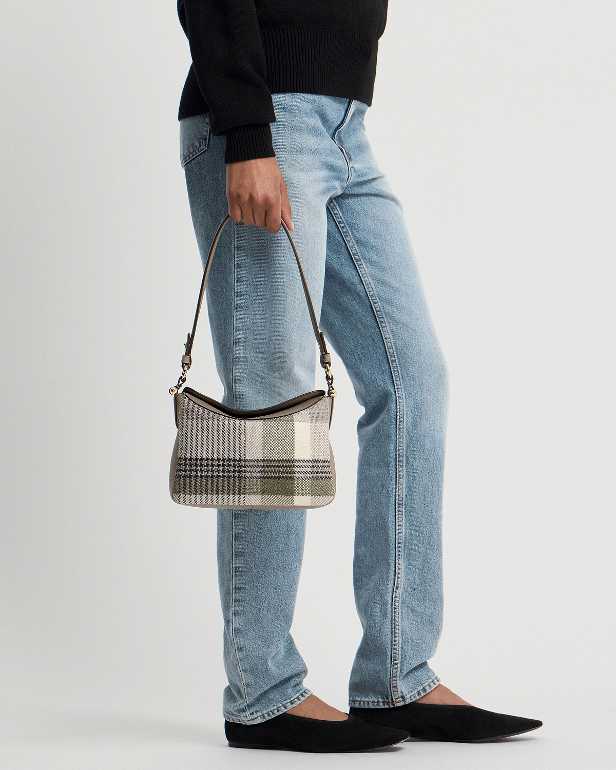 Model waist-down holding tartan taupe shoulder bag with short top handle