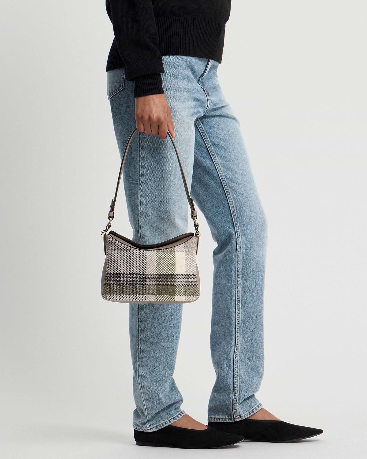 Model waist-down holding tartan taupe shoulder bag with short top handle