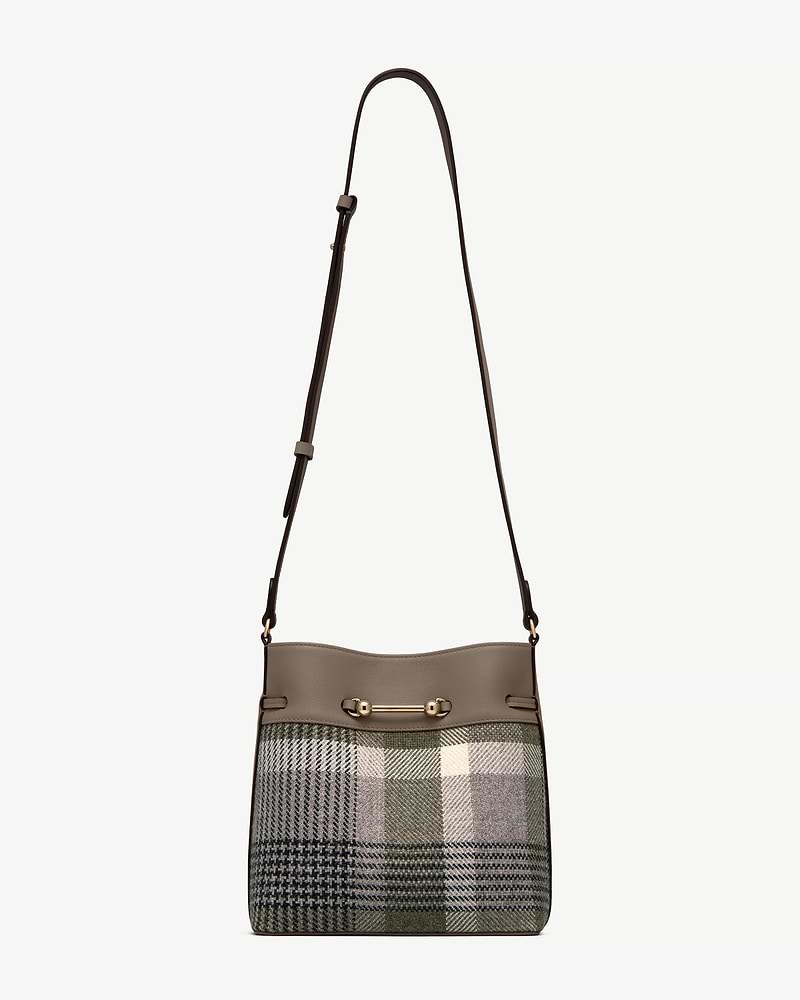 Tartan bucket bag with taupe leather trim, adjustable shoulder strap, gold bar hardware.