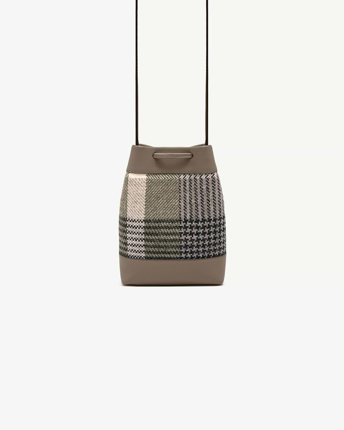 Tartan patchwork bucket pouch with taupe leather trim and thin shoulder strap.