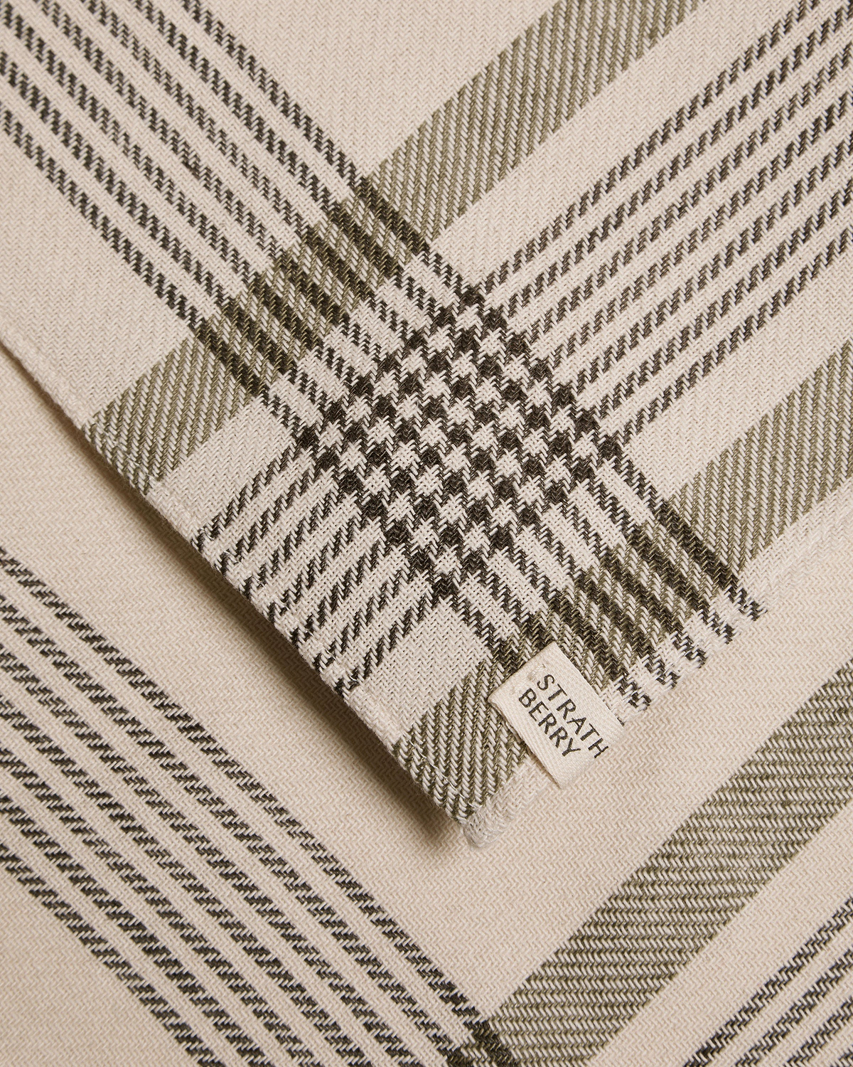 Beige and olive tartan cotton-linen table runner with Strathberry label.