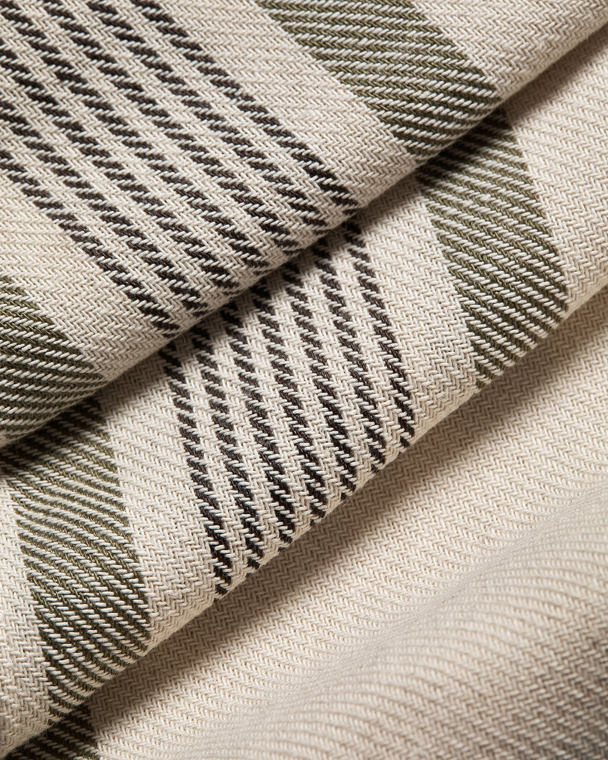 Woven cotton-linen table runner with green and brown tartan stripes.