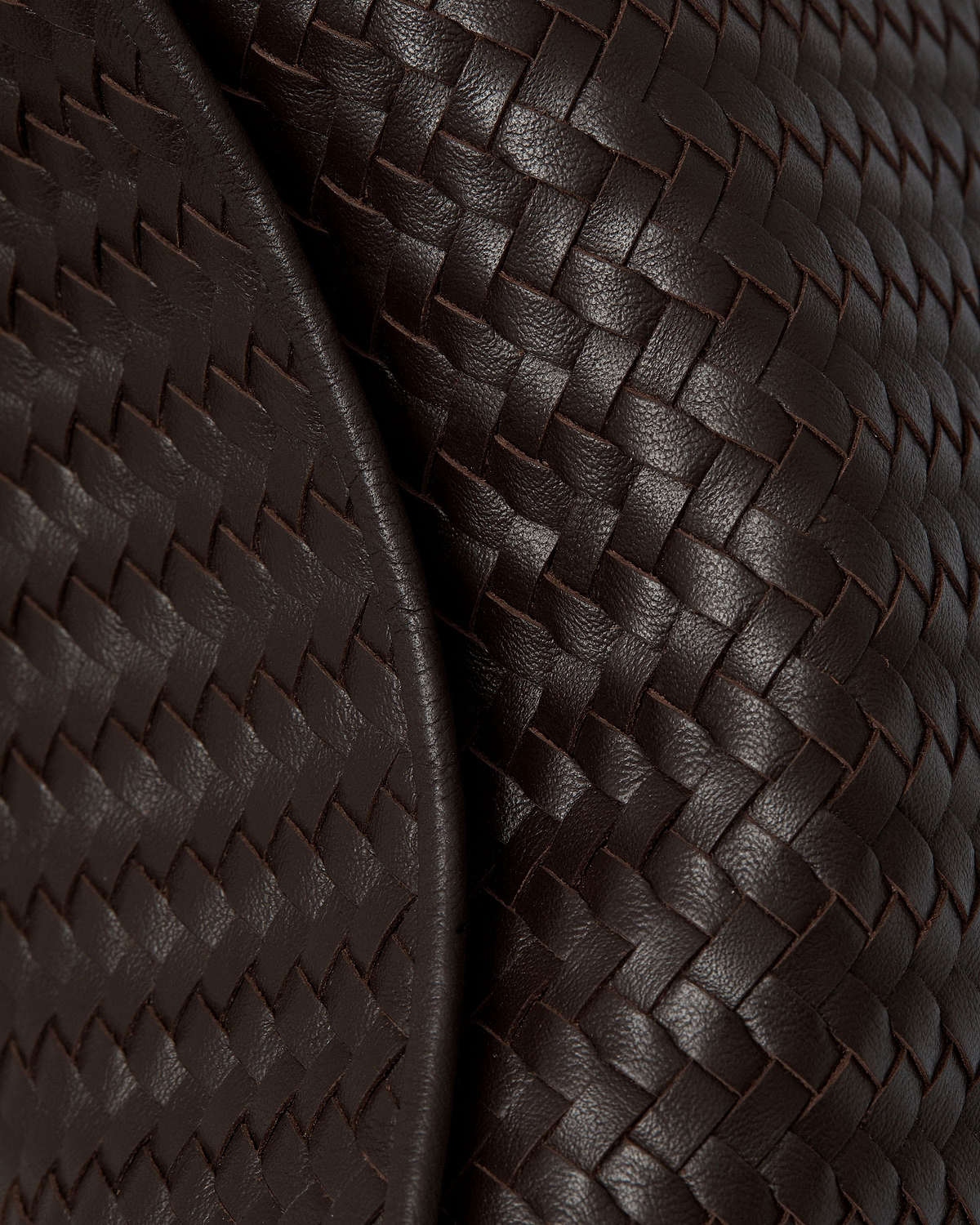 Chocolate woven leather showing braided texture and dimensional weave pattern