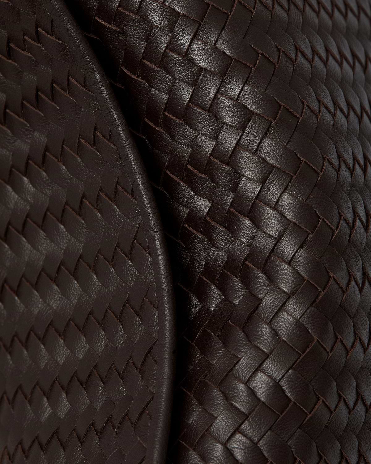 Chocolate woven leather showing braided texture and dimensional weave pattern