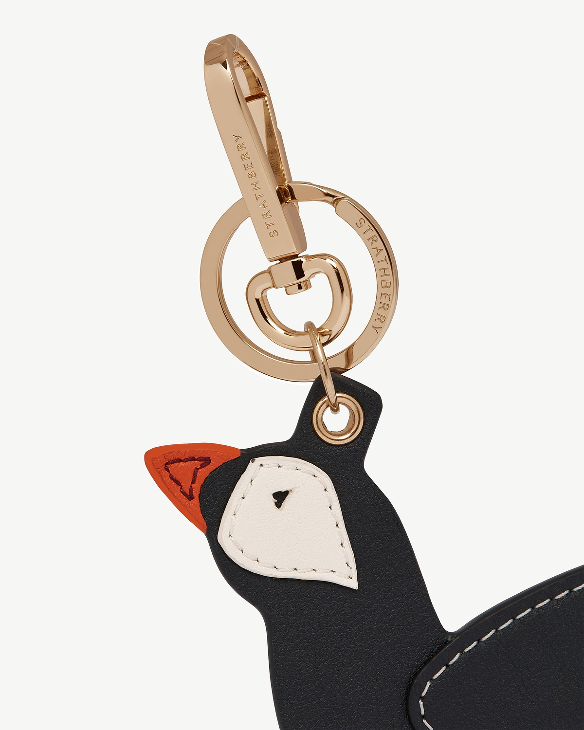 Puffin-shaped leather bag charm in black, vanilla and marmalade with Strathberry hardware.