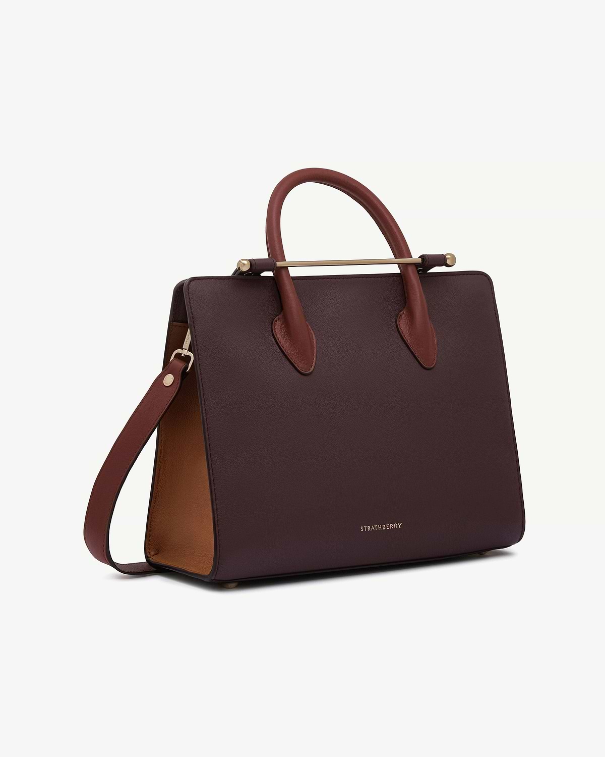 Burgundy leather midi tote with walnut interior, chestnut handles and Strathberry logo.