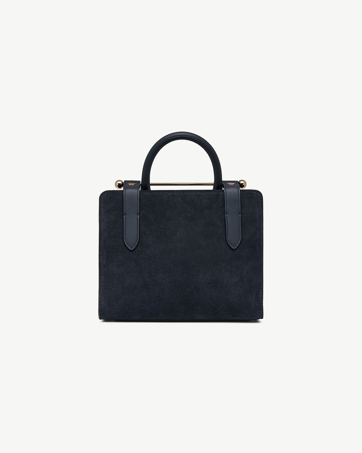 Navy suede mini tote with top handles and gold metal bar detail.