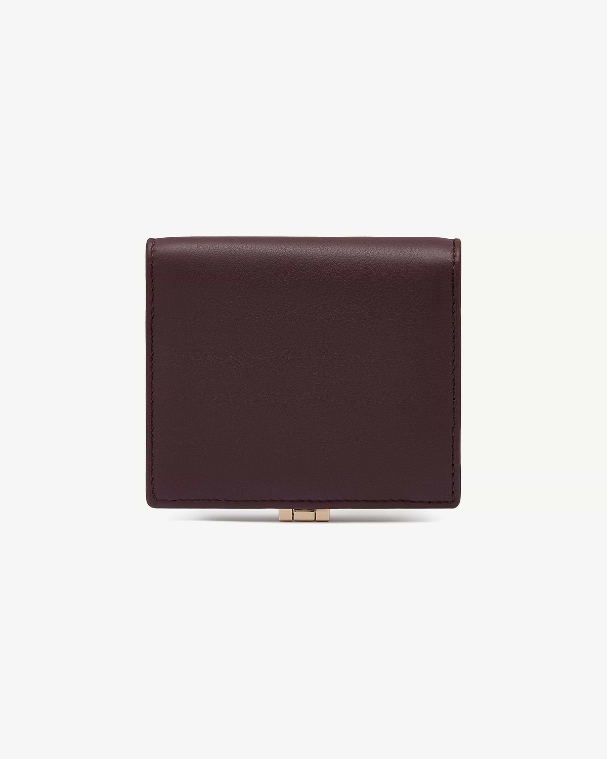 Top section of burgundy and walnut leather wallet with gold clasp.