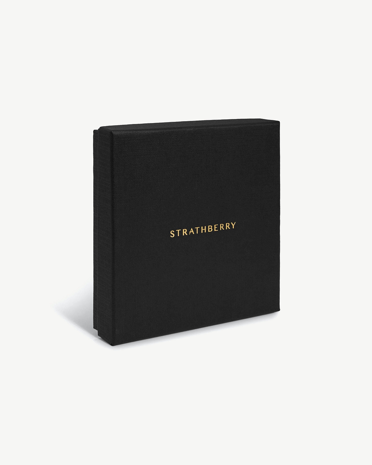 Black textured box with gold Strathberry logo, standing upright on white background.