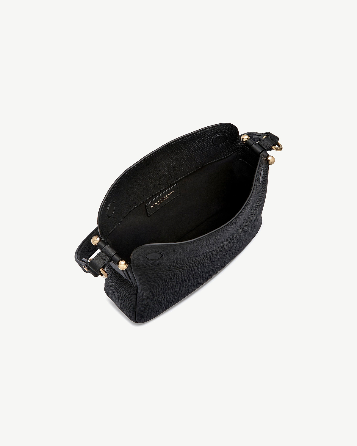 Strathberry Sway black leather bag shown open with gold hardware and strap.