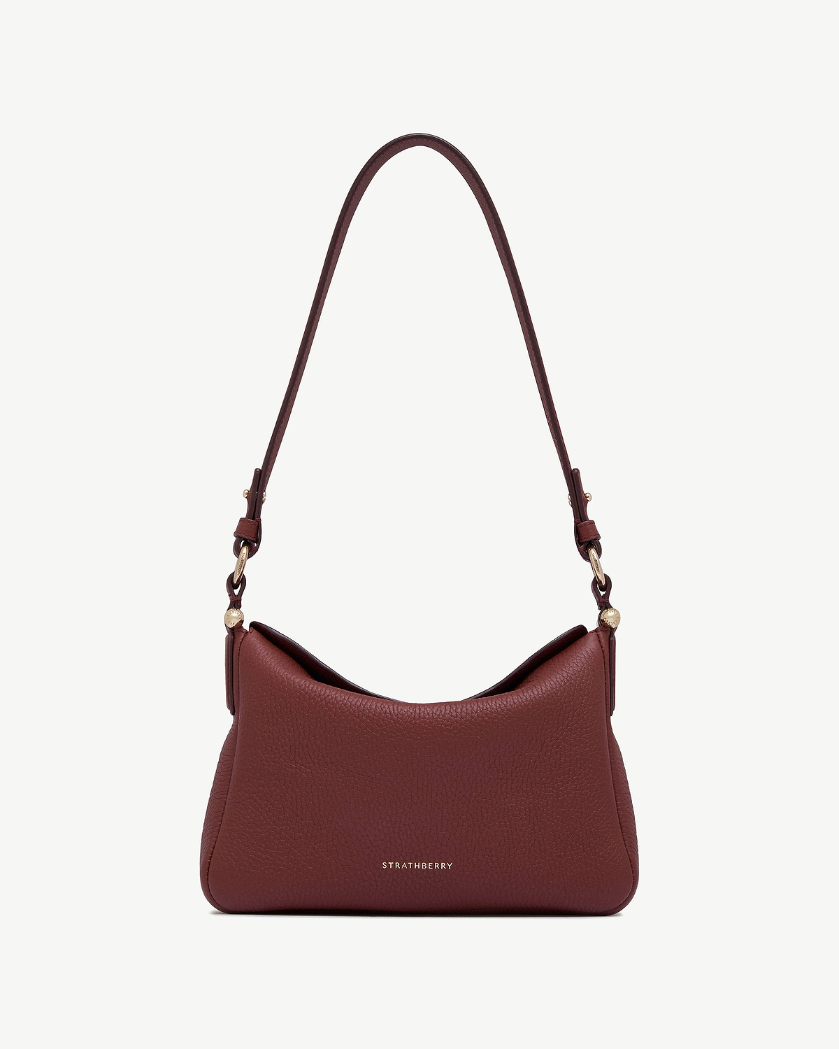 Strathberry Sway oxblood leather shoulder bag with long strap and gold hardware.