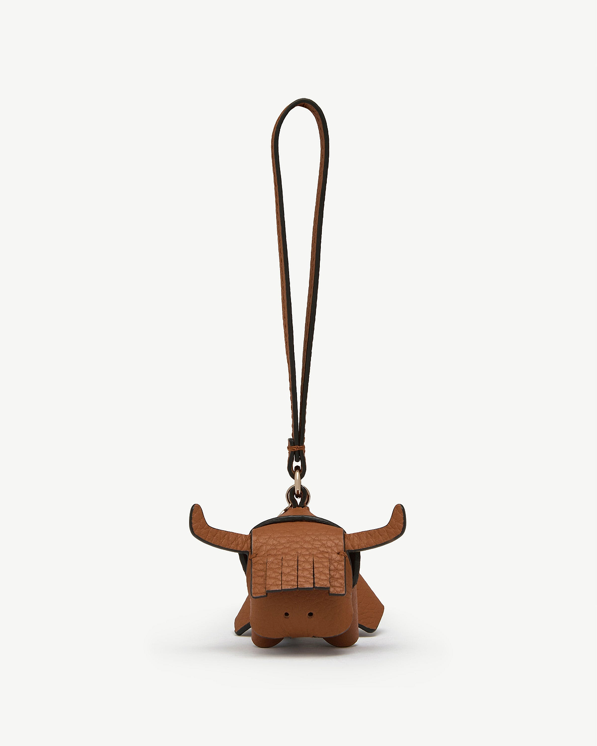 Tan leather highland cow bag charm with fringe, horns and long hanging strap.