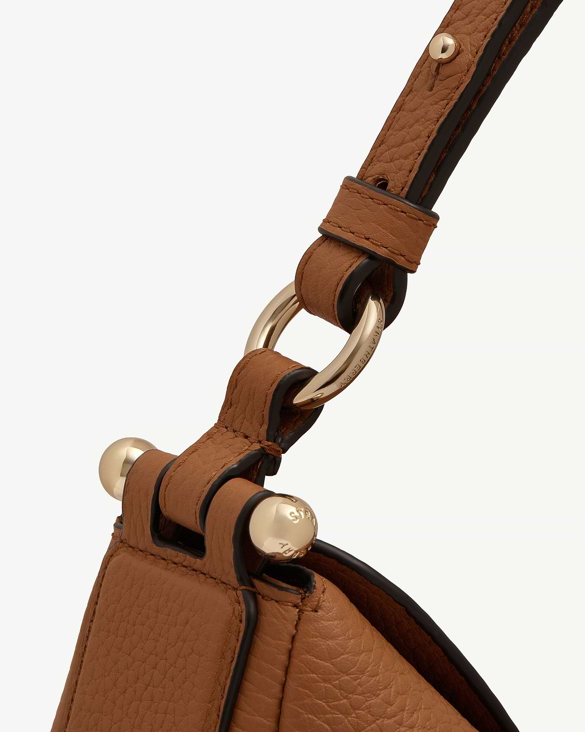 Tan Sway Maxi leather strap with gold ring hardware engraved Strathberry.