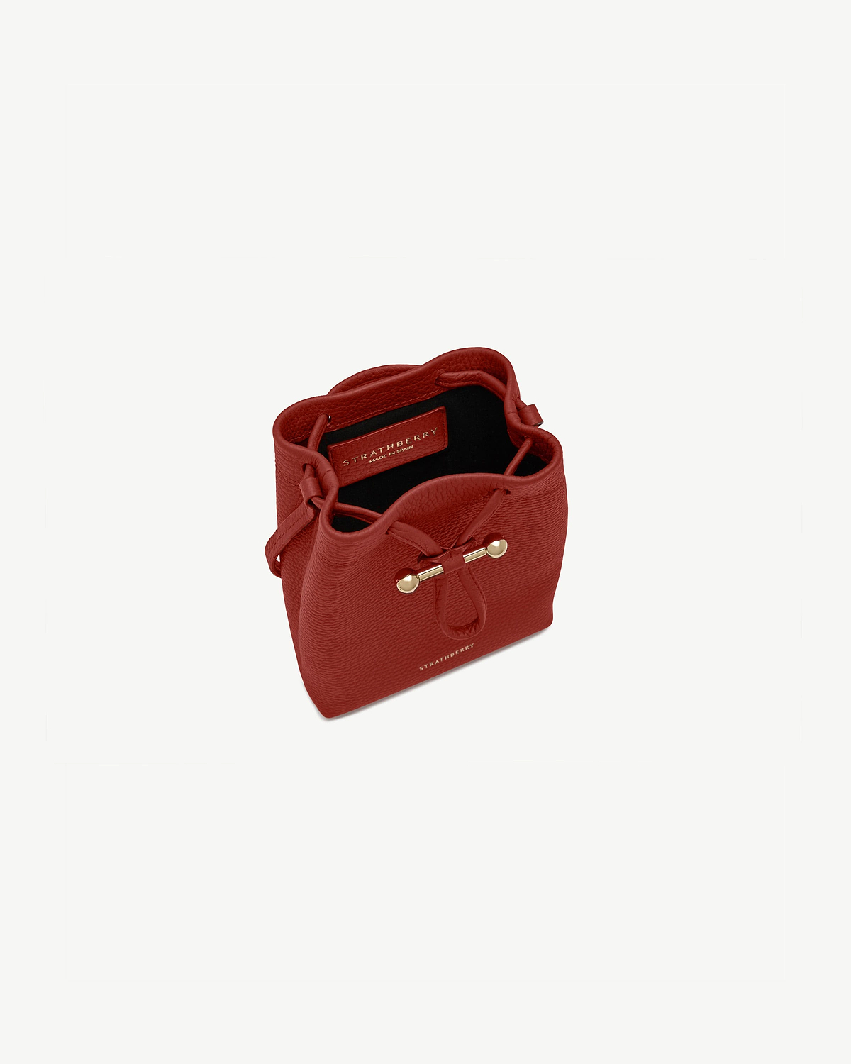 Strathberry Osette midi pouch in Levanto red with drawstring and gold bar.