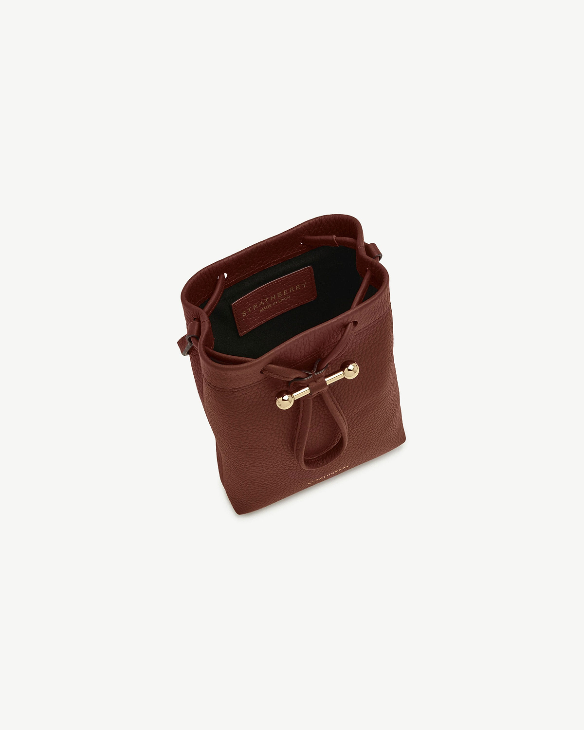 Walnut Strathberry Osette Midi pouch with drawstring top and gold bar detail.