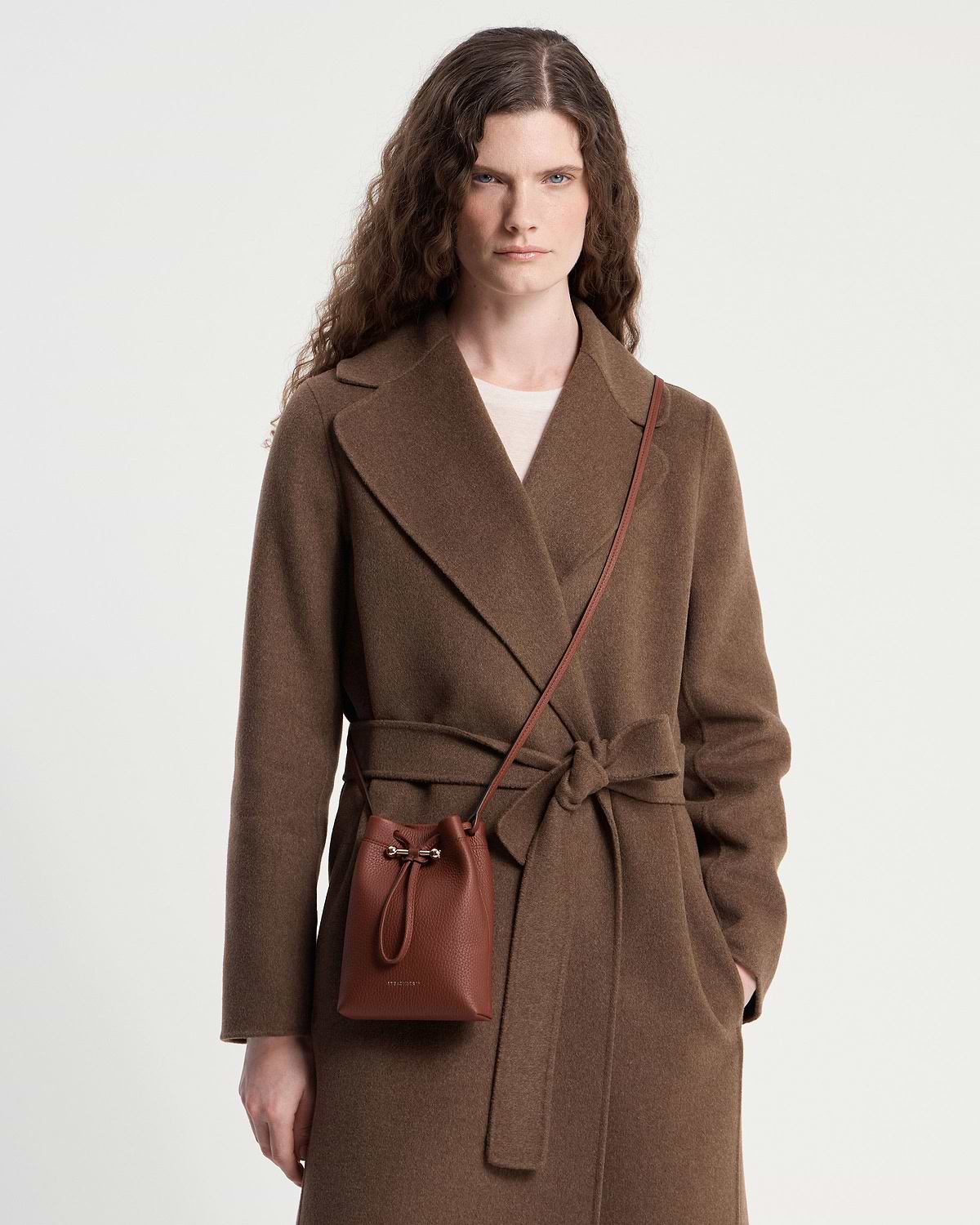 Model wearing brown coat with walnut Osette midi pouch crossbody bag.
