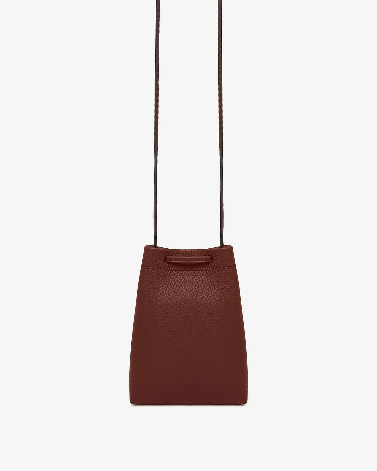 Walnut leather midi pouch with long thin strap and pebbled texture.