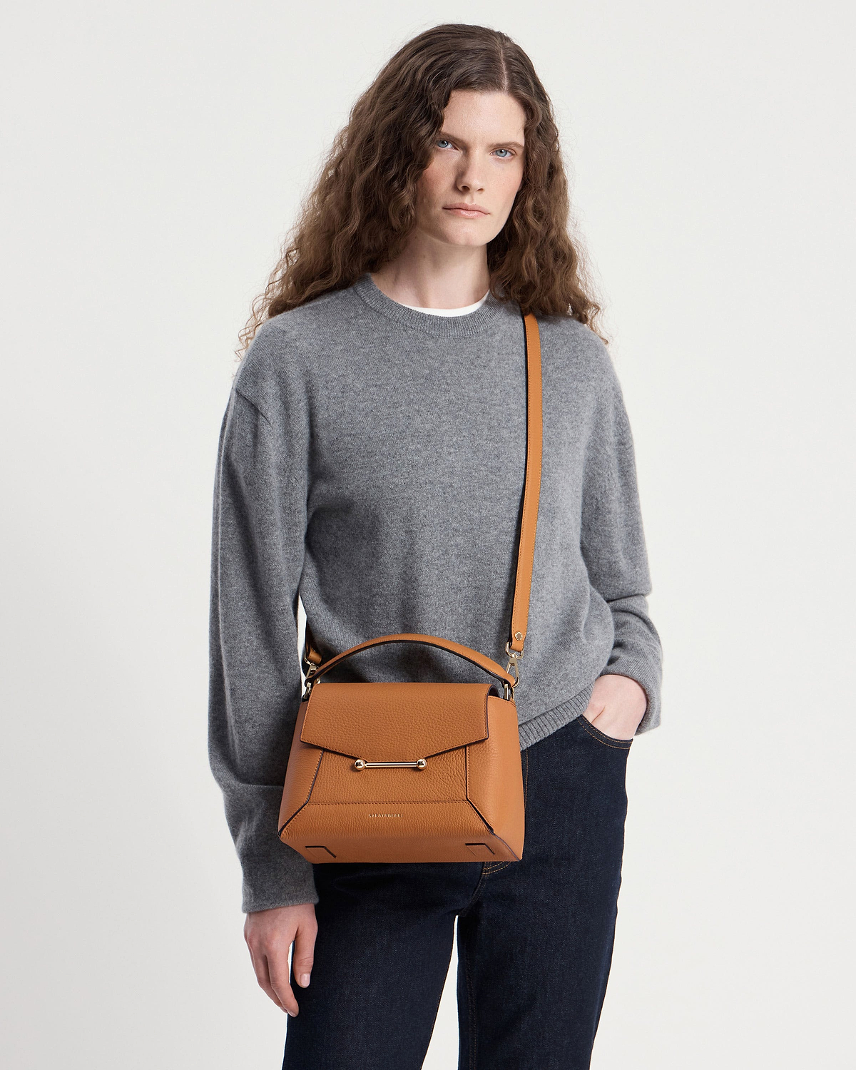 Model wearing grey sweater with honey mosaic bag, top handle and shoulder strap.