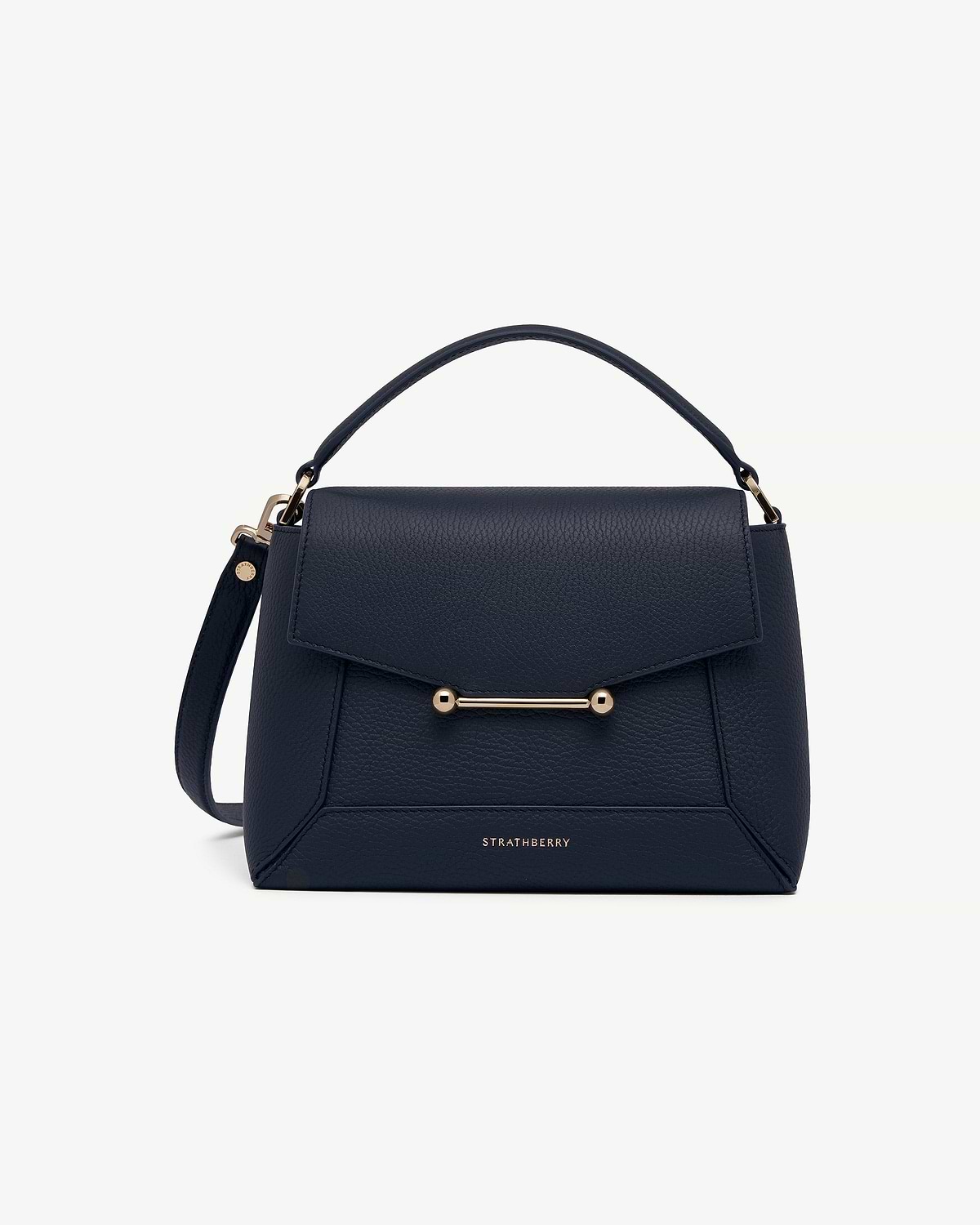 Strathberry navy mosaic bag with top handle, flap and gold bar detail.