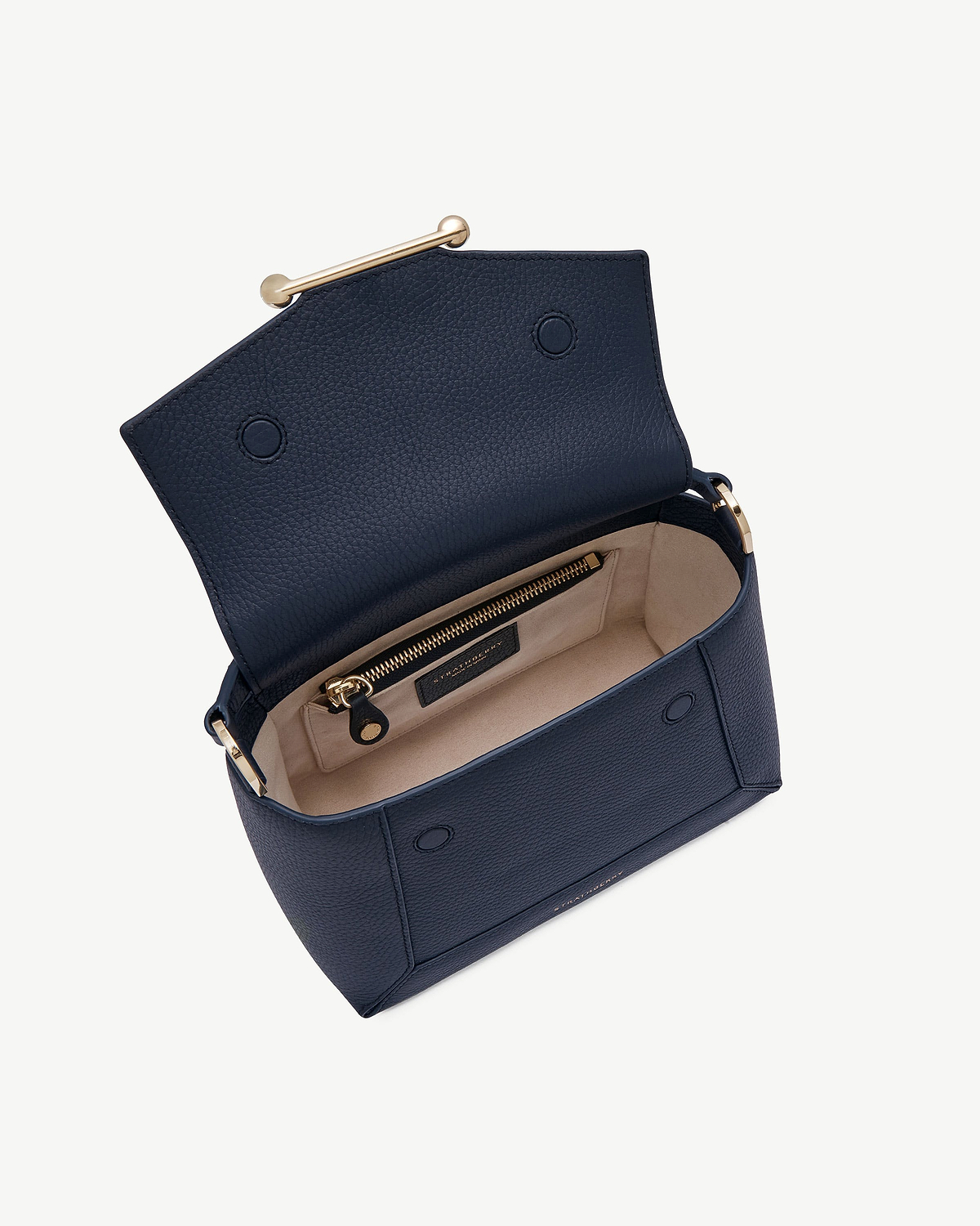 Navy Mosaic bag open showing beige interior, zip pocket, gold hardware, Strathberry label.