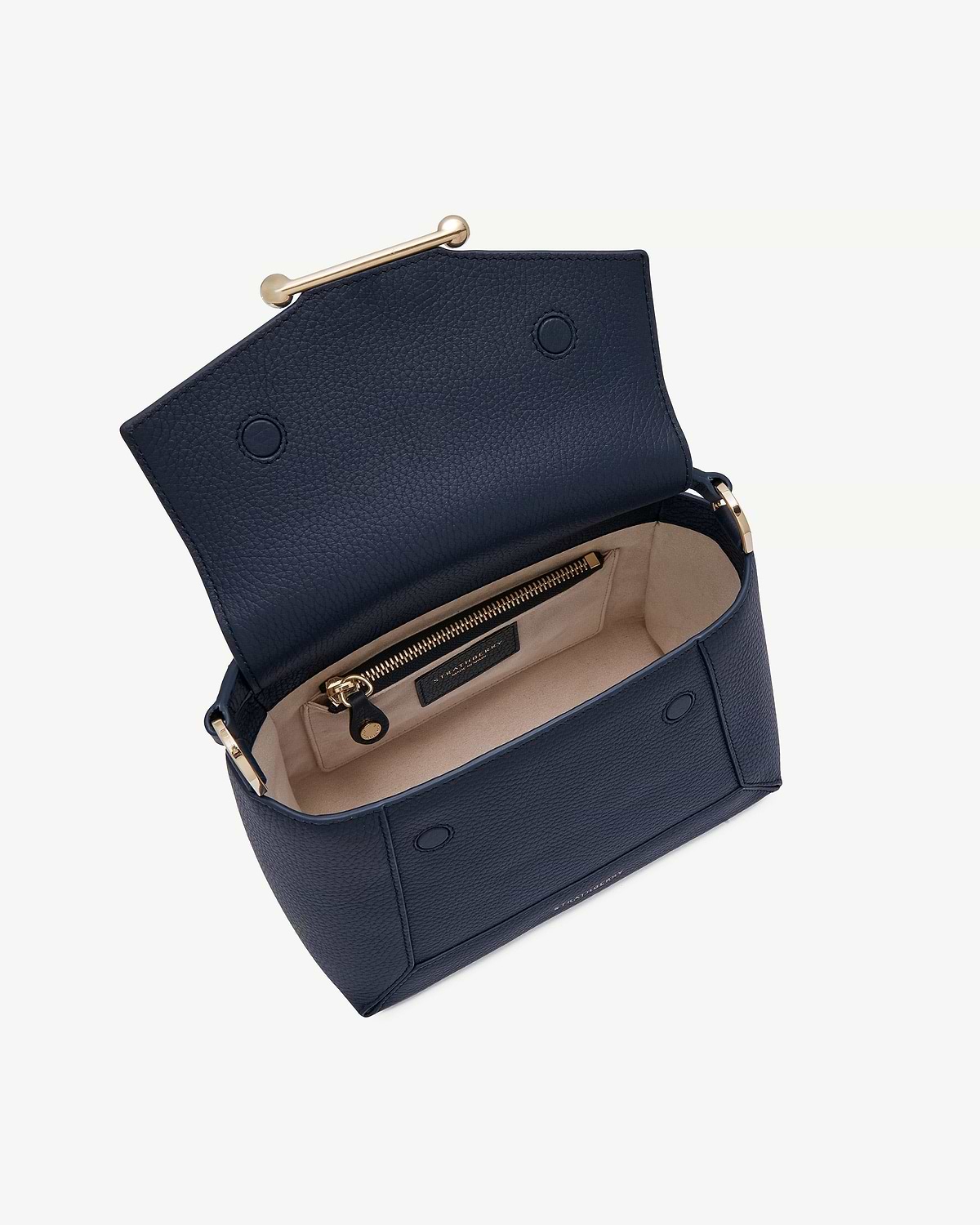 Navy Mosaic bag open showing beige interior, zip pocket, gold hardware, Strathberry label.