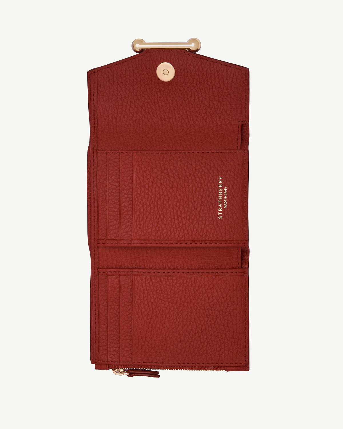 Strathberry Levanto red trifold wallet open, showing card slots and zip pocket.