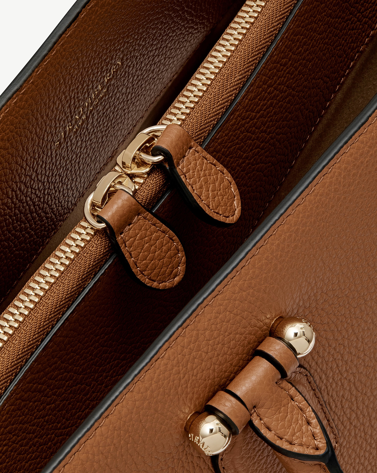 Tan leather bag interior zip, strap and gold Strathberry hardware.