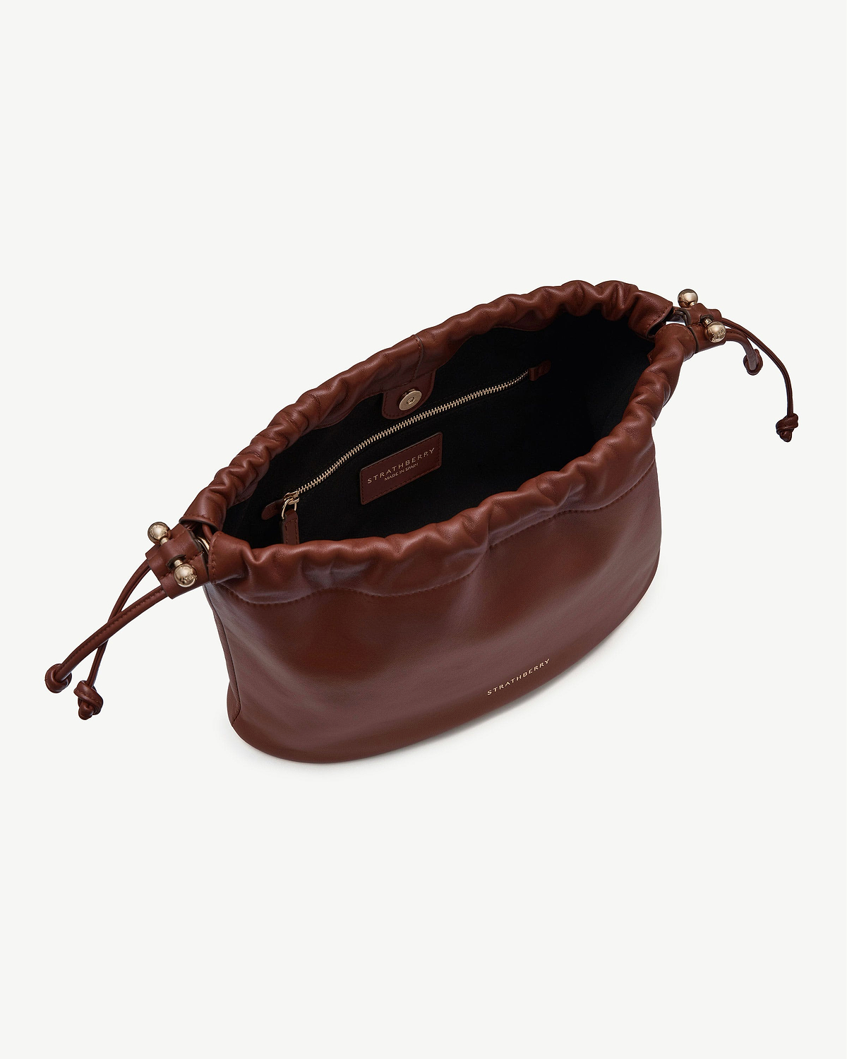 Walnut leather Charlotte Midi Drawstring bag open, visible Strathberry logo and gold hardware
