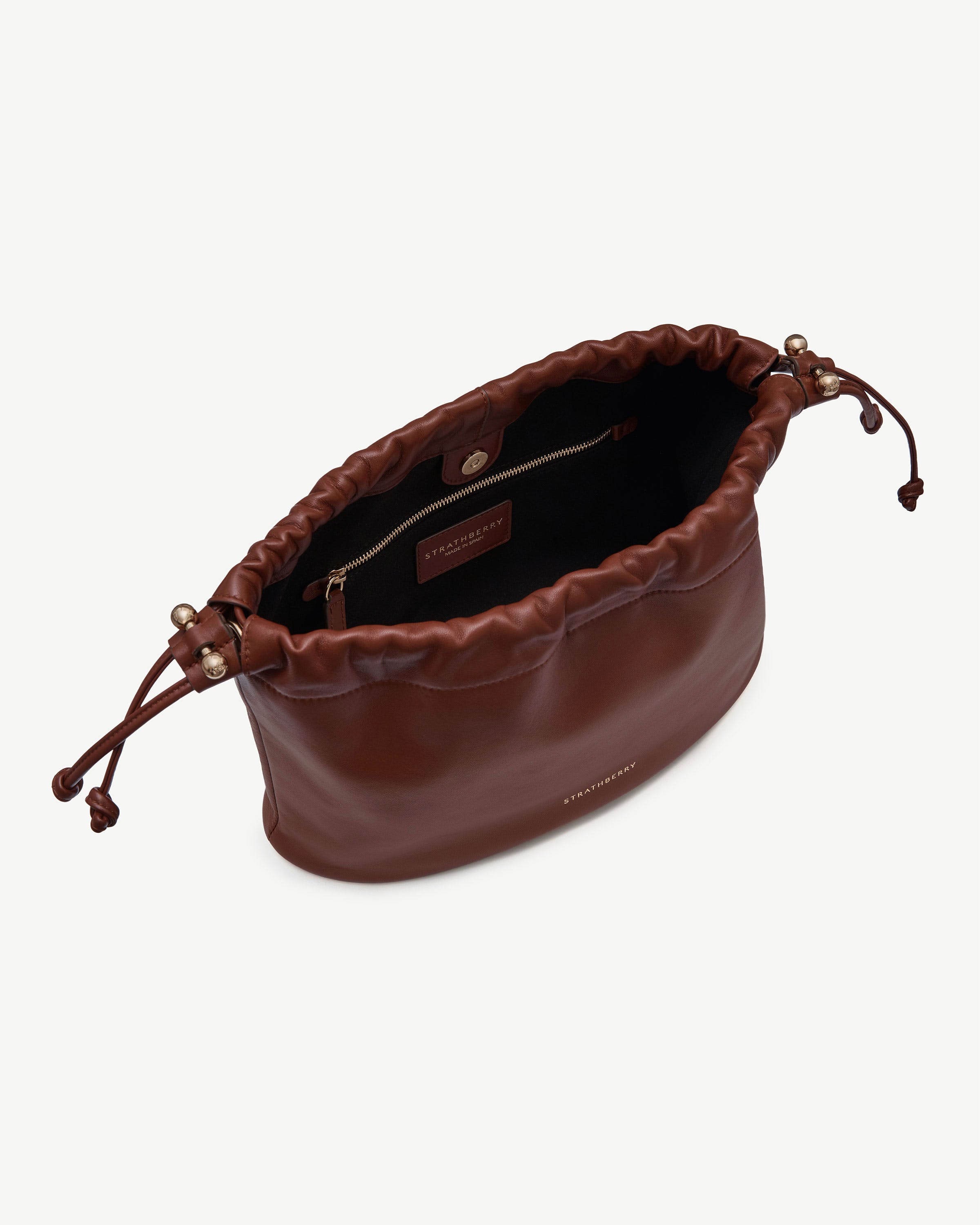 Walnut leather Charlotte Midi Drawstring bag open, visible Strathberry logo and gold hardware