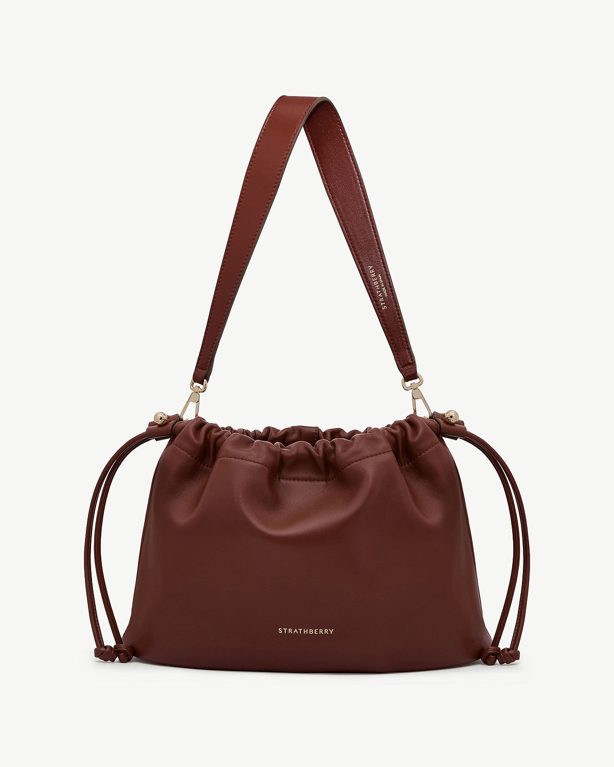 Strathberry Charlotte midi drawstring bag in walnut with leather shoulder strap.