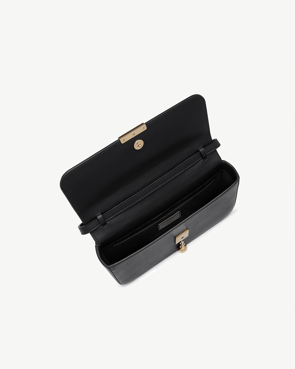 Black leather clutch open showing interior compartments and gold clasp.