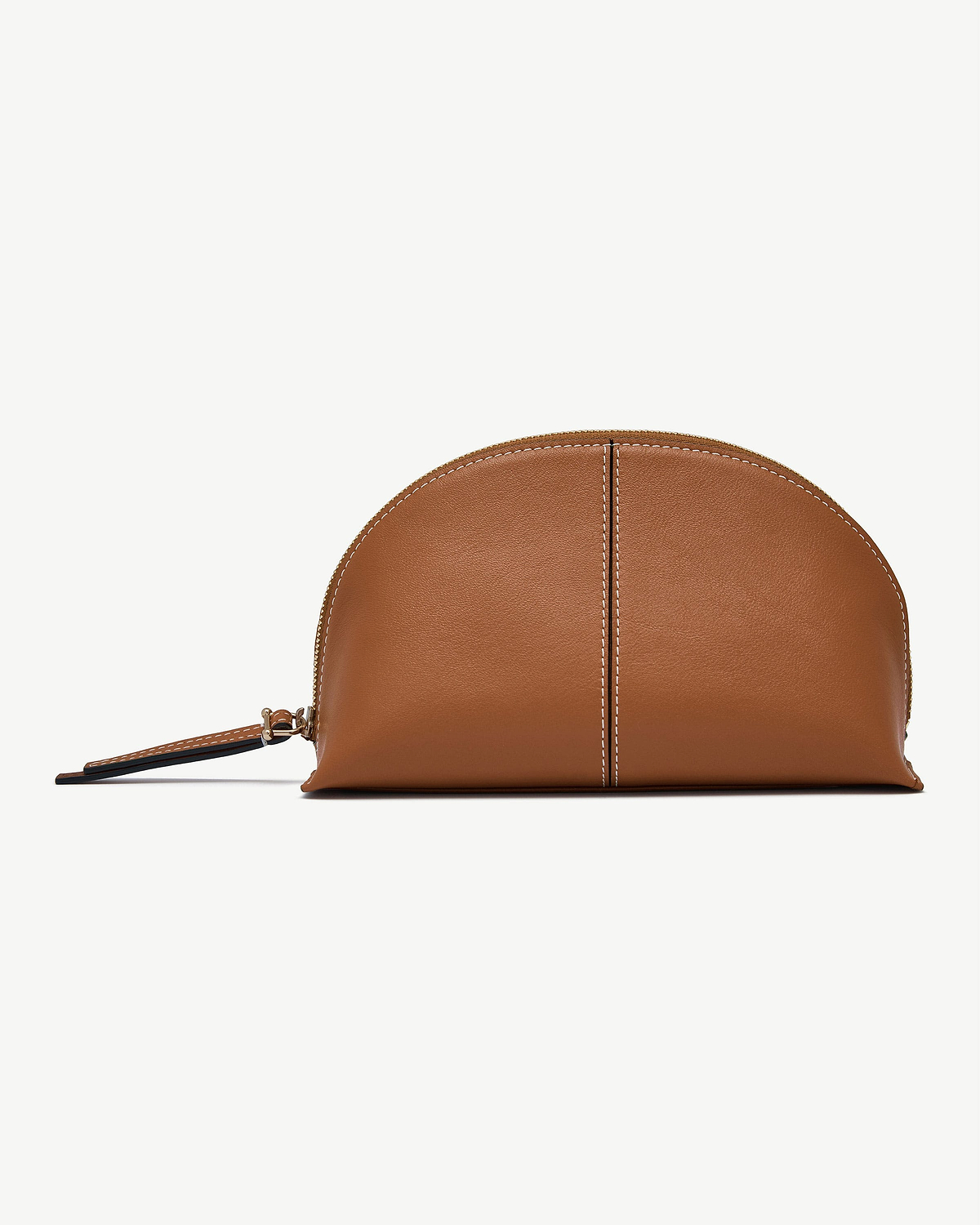 Tan leather Nest pouch with central seam, white topstitching, zip and wrist strap.