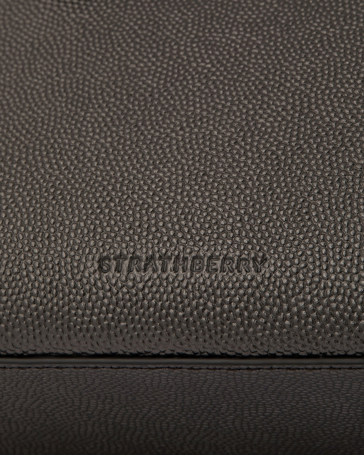 Pebbled metallic anthracite caviar leather with Strathberry embossing and stitching.