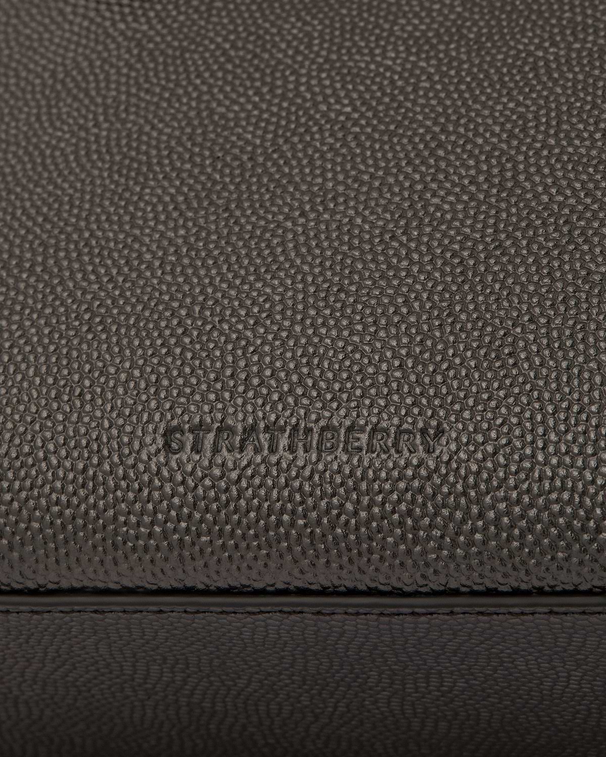 Pebbled metallic anthracite caviar leather with Strathberry embossing and stitching.