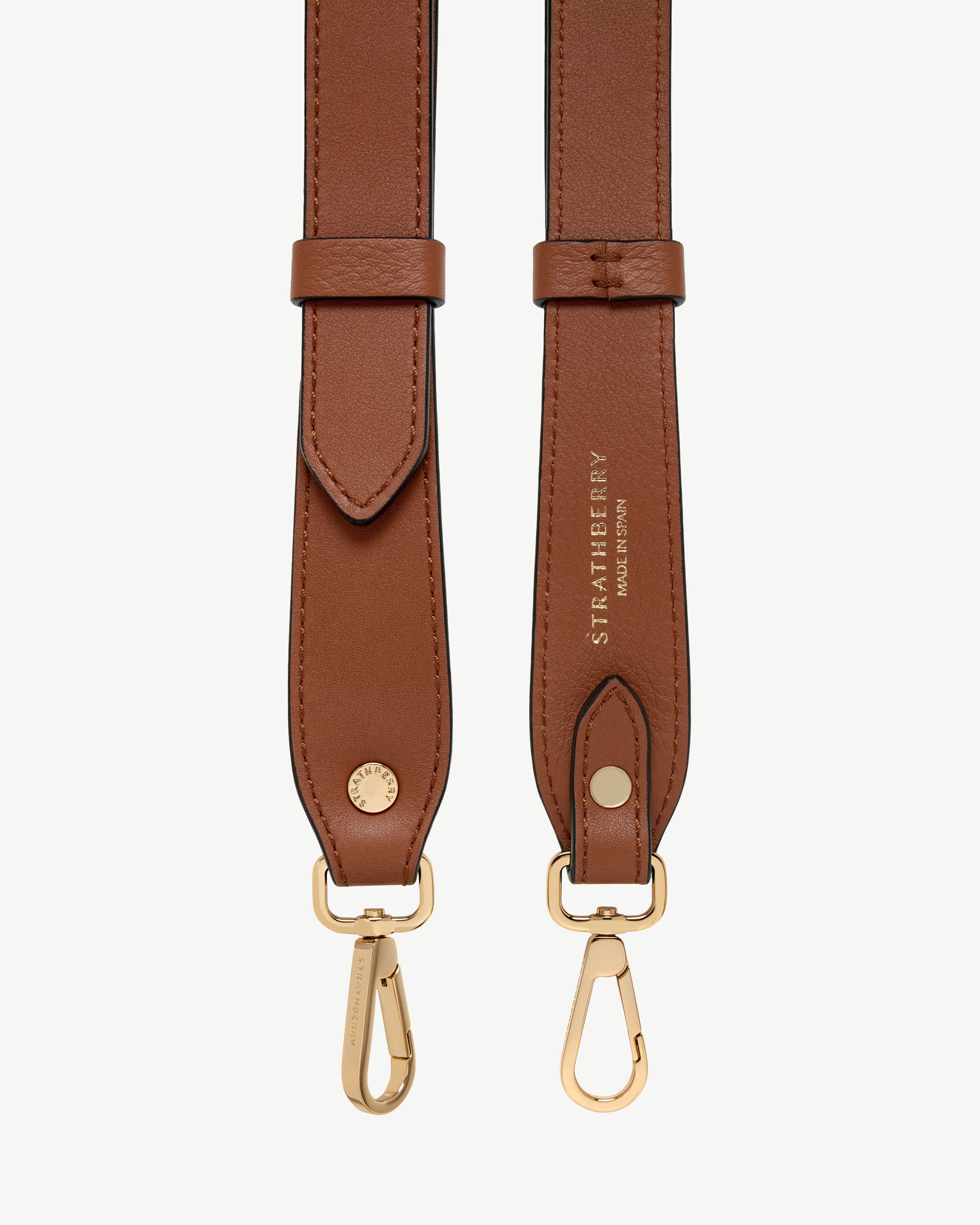 Chestnut adjustable leather strap with gold fittings and Strathberry logo.