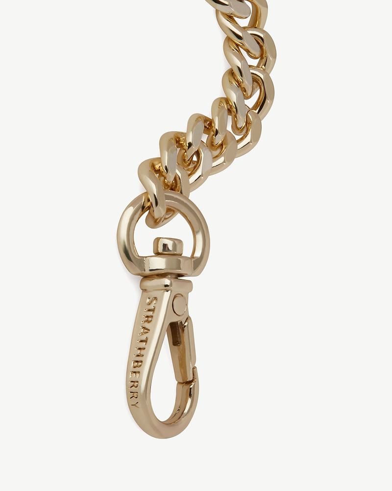 Gold chain extender with Strathberry engraved swivel clasp and loop