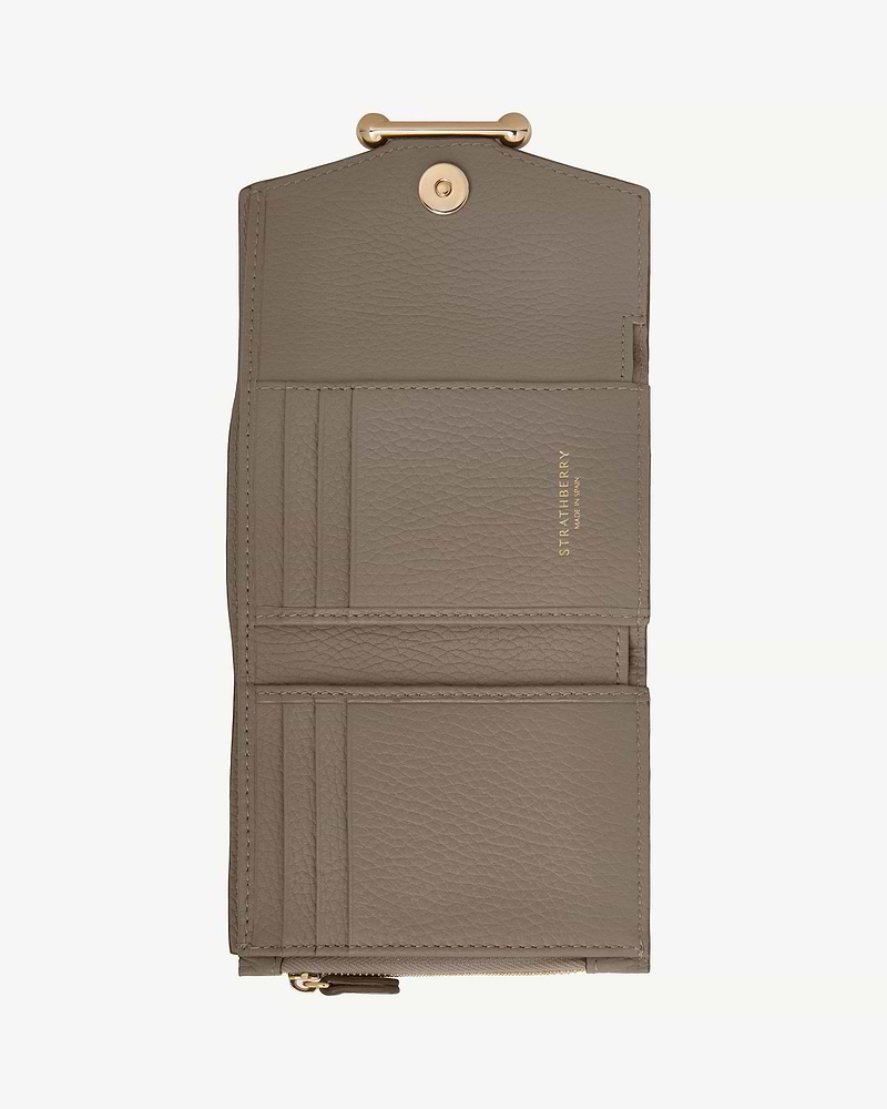 Taupe Strathberry trifold leather wallet, open showing card slots and gold clasp.