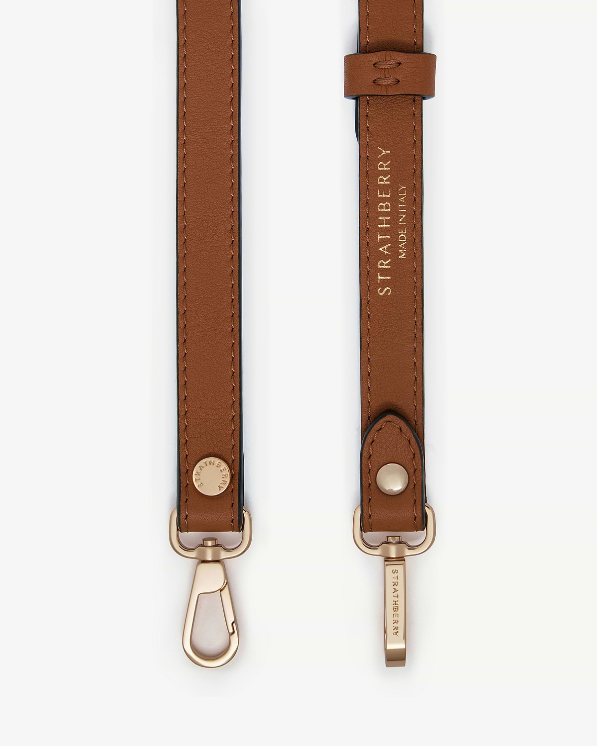 Chestnut thin adjustable leather strap with gold hardware and Strathberry wordmark.
