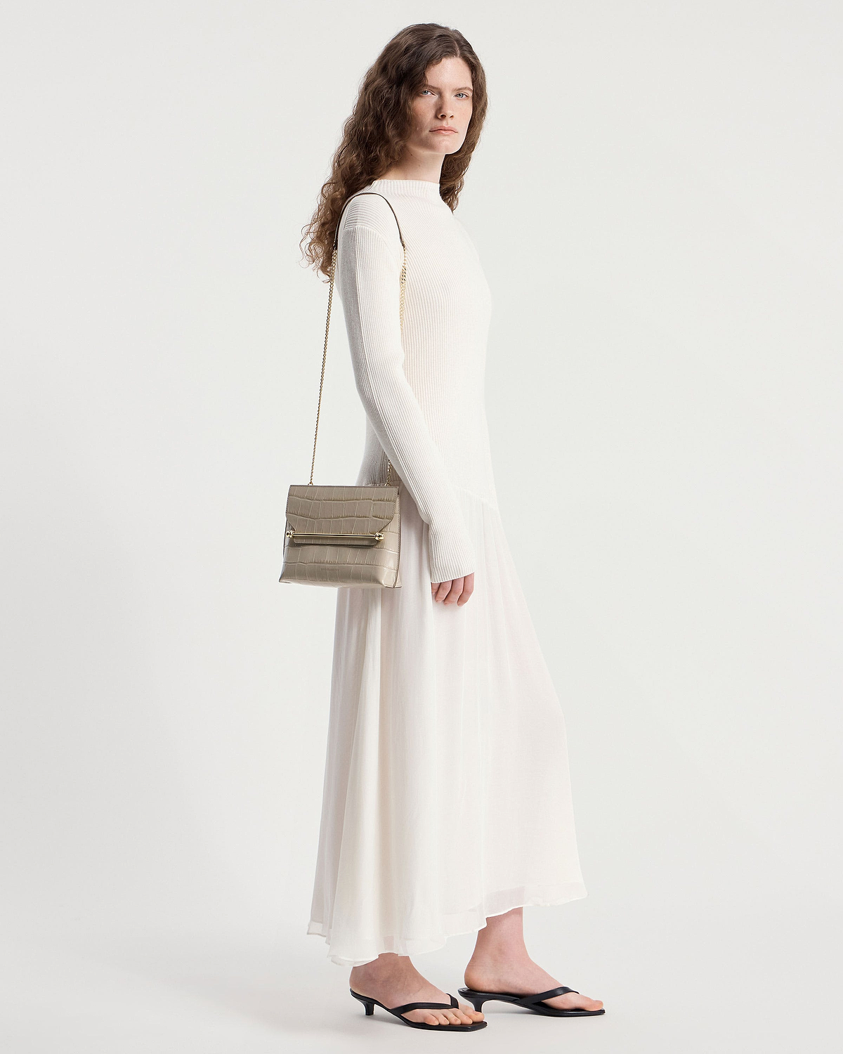 Model wearing a croc-effect Stylist bag with chain strap over shoulder