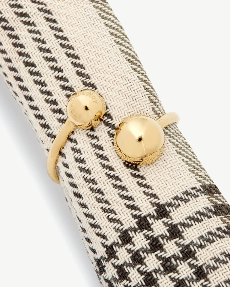 Woven beige herringbone fabric with light gold metal buttons engraved 'Strathberry'.