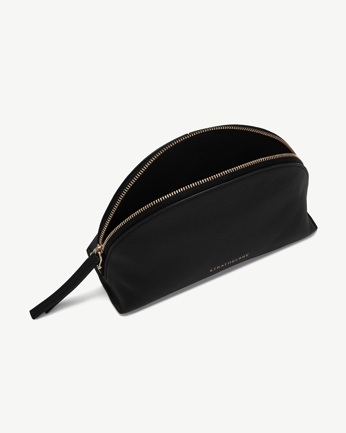 Black leather nest pouch with gold zip and Strathberry logo.