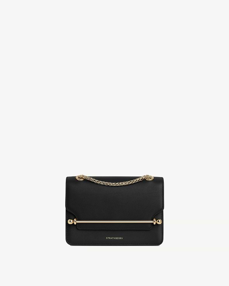 Black Strathberry East/West Mini bag with gold chain and bar detail.