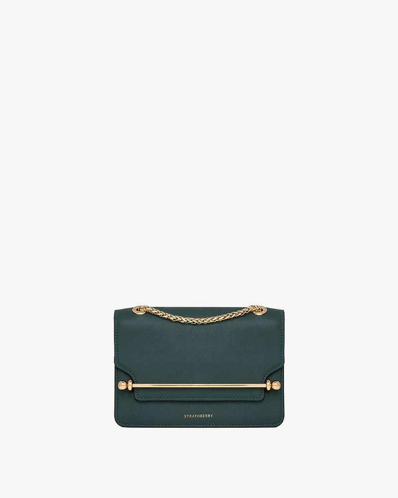 Bottle green East/West Mini bag with gold chain strap, bar hardware, Strathberry logo.