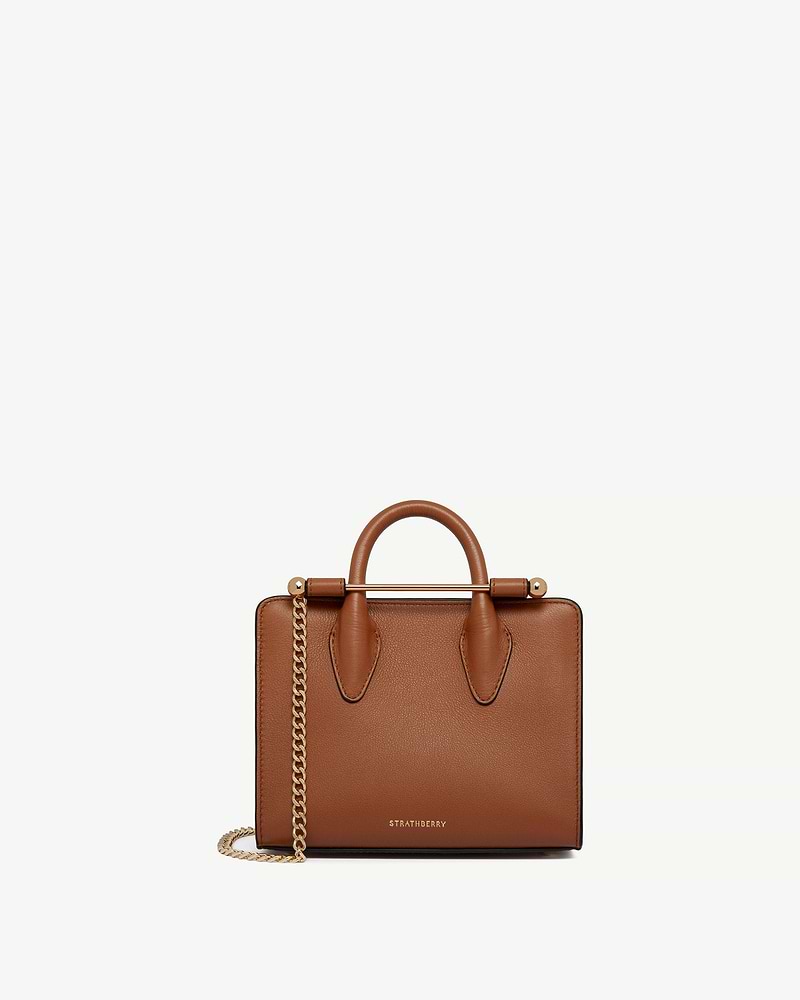 Chestnut leather Strathberry nano tote with top handles, gold bar and chain strap.